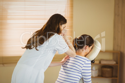 Young woman getting massage in chair