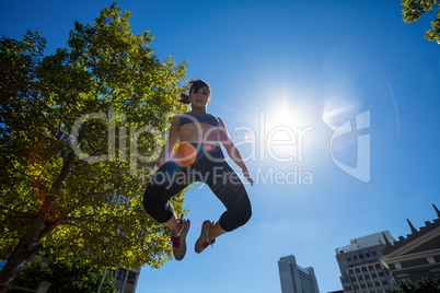 Low angle view of athletic woman jumping in the air