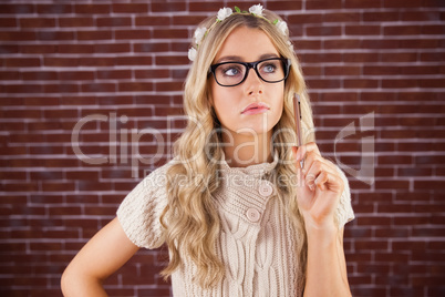 Gorgeous thoughtful blonde hipster holding pen