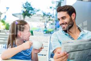 Happy father and his daughter having breakfast together