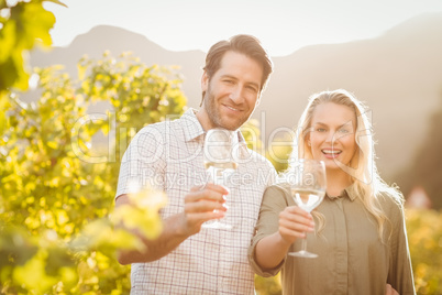 Young happy couple holding glasses of wine