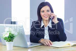Businesswoman on a call at her desk