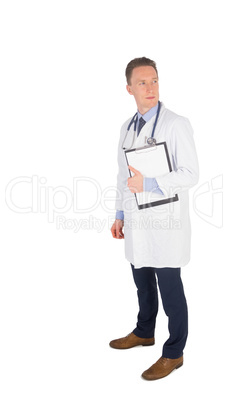 Concentrated doctor holding a clipboard