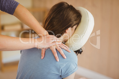 Young woman getting massage in chair