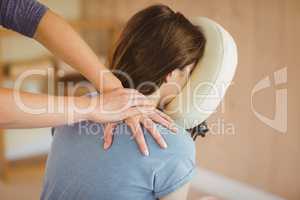 Young woman getting massage in chair