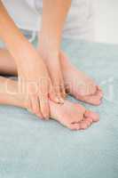 Close-up of a woman receiving foot massage