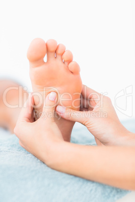 Close-up of a woman receiving foot massage