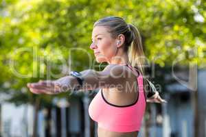 A beautiful athlete stretching her arms