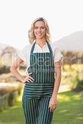 Smiling farmer woman with hands on hips