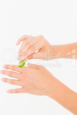 A woman put aloe vera on his hand