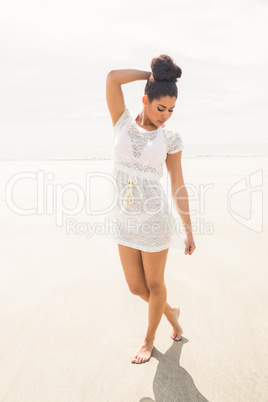 Stylish girl posing on the sand