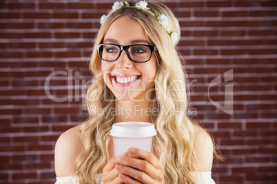 Gorgeous smiling blonde hipster with floral headband and coffee