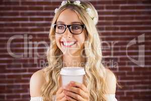 Gorgeous smiling blonde hipster with floral headband and coffee