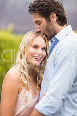 Young happy man kissing woman on the forehead