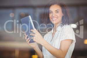 Smiling woman using a digital tablet