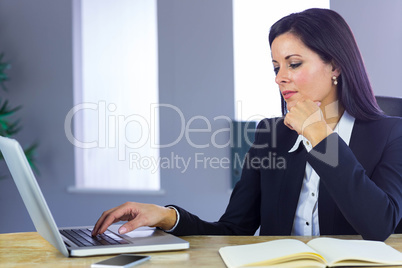 Businesswoman working with laptop at desk