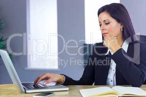 Businesswoman working with laptop at desk