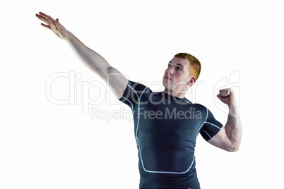 Muscular rugby player pointing to the sky