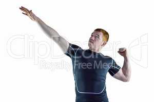 Muscular rugby player pointing to the sky