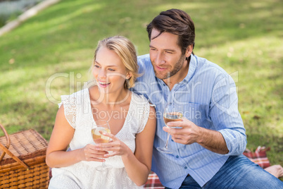 Couple on date holding a glass of white wine