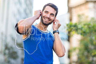 An handsome athlete listening to music