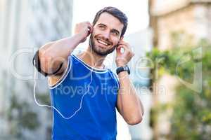 An handsome athlete listening to music