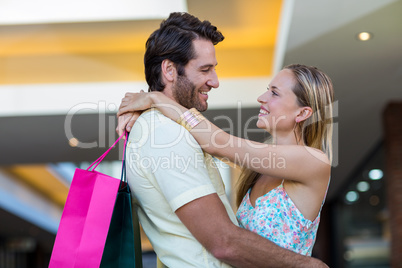 Smiling couple embracing and looking at each other