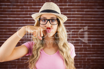 A beautiful hipster having a fake distinguished mustache