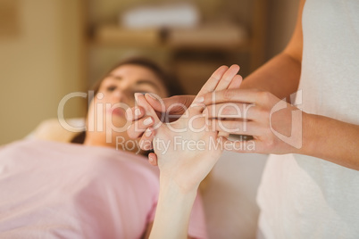 Young woman getting hand massage