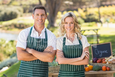 Smiling farmer couple looking at the camera