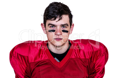 Serious american football player looking at camera