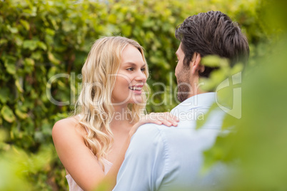 Young happy couple smiling at each other