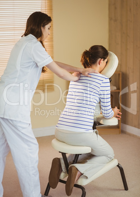 Young woman getting massage in chair