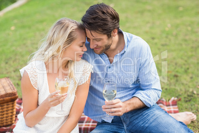 Couple on date holding white wine glasses