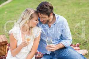 Couple on date holding white wine glasses