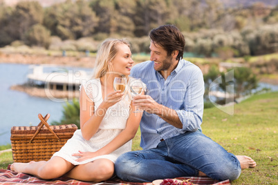 Couple on date toasting with glass of white wine