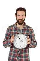 Handsome hipster showing a clock