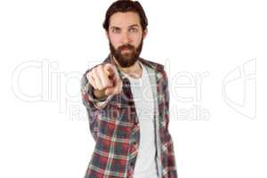 Handsome hipster pointing at camera