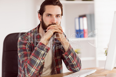 Hipster businessman sitting at his desk