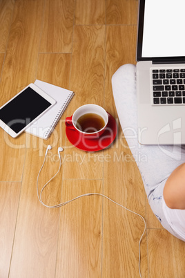 Overhead shot of laptop, tablet, coffee and headphones