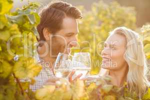 Young happy couple holding glasses of wine