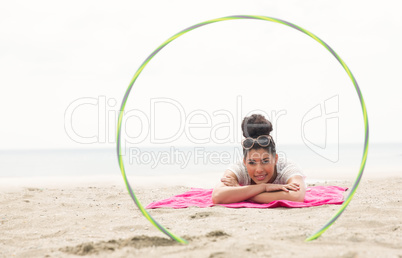 Smiling woman looking at camera through hula hoop