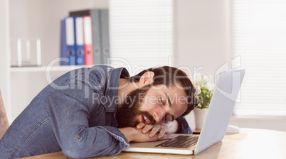 Hipster businessman sleeping at his desk