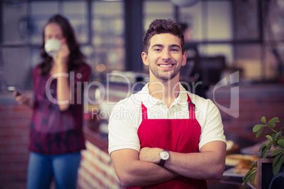 Handsome waiter with arms crossed