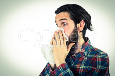 Handsome hipster blowing his nose