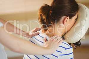 Young woman getting massage in chair