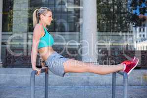 A beautiful woman stretching her body against pipes