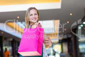 Smiling woman with shopping bags