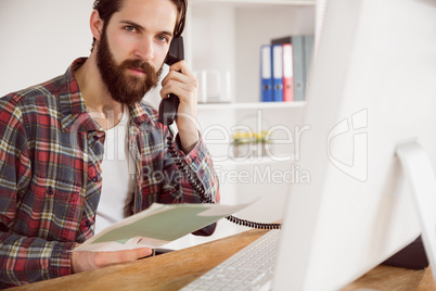 Hipster businessman working at his desk