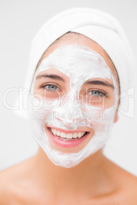 Pretty woman having white cream on her face